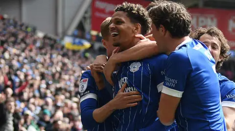Omari Kellyman (second left) celebrates scoring for Cardiff with his team-mates