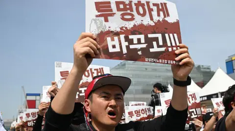 Samsung Electronics workers chant slogans during a rally ahead of a strike, scheduled to take place from May 21, on Thursday, 23 April, 2026.