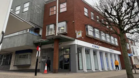 A picture of a Coral betting shop in Hinckley town centre and the office building above it 