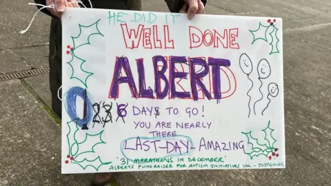 A sign which says Well Done Albert with an updated countdown at the side.