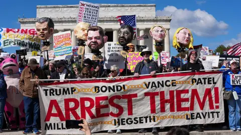 Getty Images Protestors hold effigies of members of the Trump administration as well as signs calling for their arrest