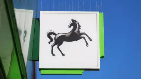 Getty Images A sign outside a bank. There is a black horse on the sign. 