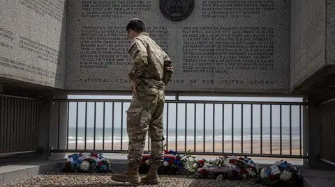  EPA-EFE/REX/Shutterstock A US Ranger visits a memorial in Omaha Beach