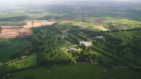 Chris/Geograph An aerial picture of the Boughton House estate, which consists of vast amounts of fields and trees.