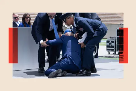 Getty Images Joe Biden is helped up after falling during the graduation ceremony at the United States Air Force Academy