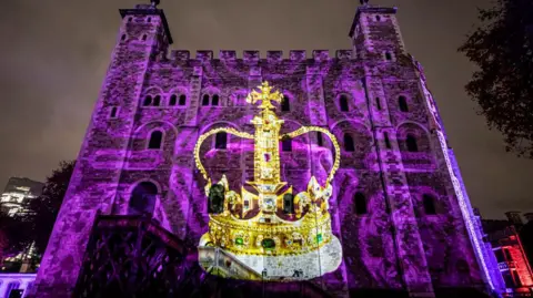 Historical Royal Palaces The Imperial State Crown projected onto the Tower of London