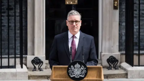 Keir Starmer stood at podium outside 10 Downing Street.