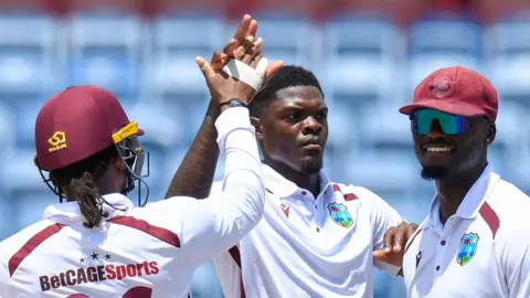 West Indies bowler Alzarri Joseph (centre) celebrates taking a wicket