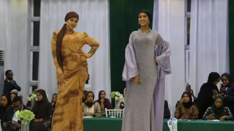 Shukri Mohamed Abdi Two women on the catwalk