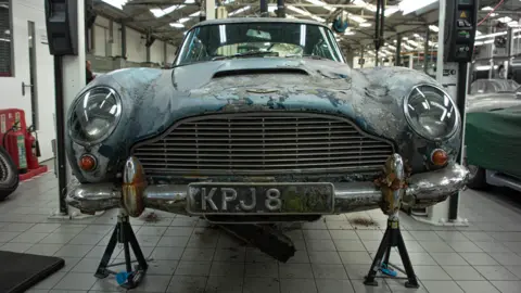 Marc Bow/Timbuktu Content The damaged chassis of the Aston Martin as it is about to be repaired on in a workshop.