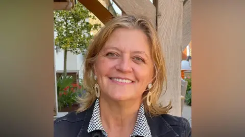 Contributed A woman is smiling at the camera and wearing a black denim jacket and polka-dot shirt. 