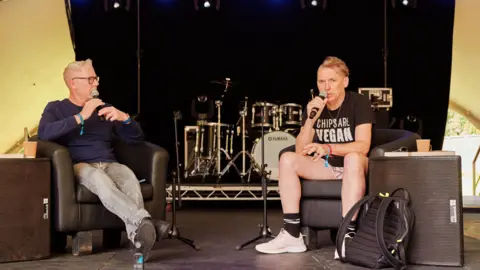 Mike Massaro/ Borkowski Arts Dale Vince speaking on stage 