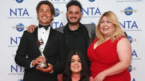 Getty Images  Aaron Evans, Wilfred Webster, Meryl Williams and Hannah Byczkowski, accepting the Reality Competition award on behalf of "The Traitors" at the National Television Awards 2023