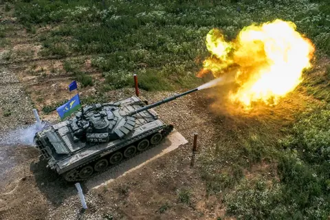 Sergei Bobylev / Getty Images A tank opens fire