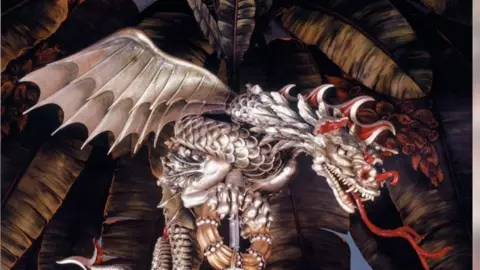 Brighton & Hove Museums A golden dragon chandelier with a red tongue coming from its mouth