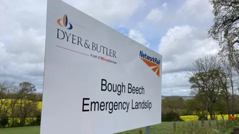 BBC/Piers Hopkirk A Network Rail sign reading: 'Bough Beech Emergency Landslip'