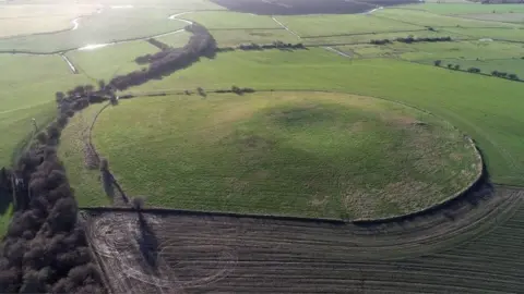 English Heritage / PA The mound of earth