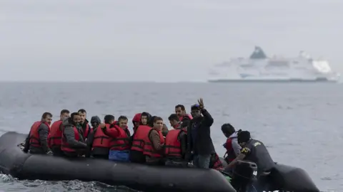 Getty Images Migrants in dinghy in English Channel