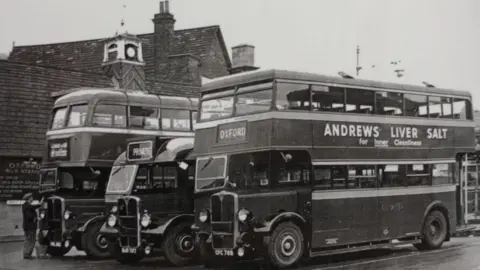 A black and white photos of several buses at Oxford Bus Station
