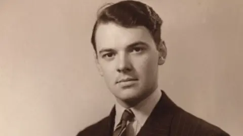 Family A black and white picture of a man with dark hair and a suit