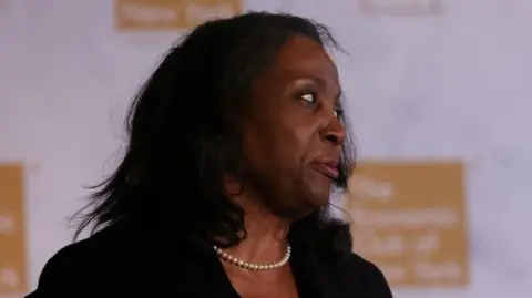 Reuters Woman wearing pearls turns her head to the left