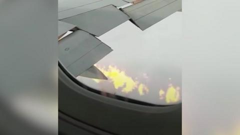 Flames shooting from aircraft's wing