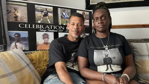 BBC A husband and wife sitting on a sofa