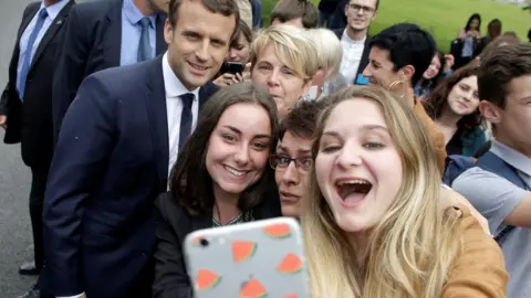 Getty Images Students take a selfie photo with French President Emmanuel Macron (Rear L) during his visit to the Vaseix agricultural college in Verneuil-sur-Vienne, France, June 9, 2017