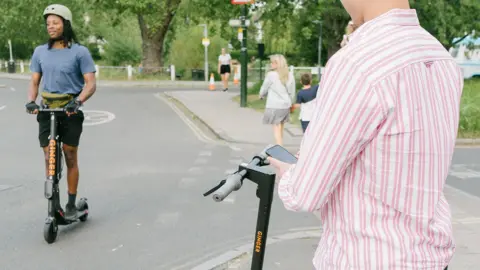 Ginger People with e-scooters