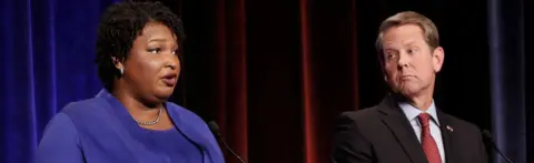 Reuters Democratic gubernatorial candidate for Georgia Stacey Abrams speaks as Republican candidate Brian Kemp looks on during a debate in Atlanta