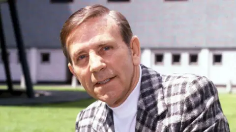 British Actor, Comedian And Entertainer Norman Wisdom in a chequered jacket in 1981.