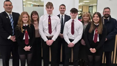 A line up of pupils and staff at the new Galashiels Academy. The pupils are wearing the school's purple tie.