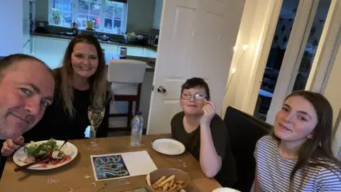 PAula O'Sullivan A family sat at a table