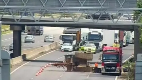 M6 shut as lorry carrying machinery hits bridge