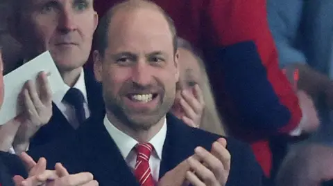 William smiling and applauding in the stands at the principality stadium