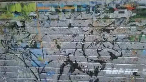 Alexander Smith Image of Banksy's graffiti on a wall at the club.