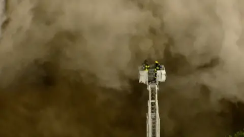 Two firefighters engulfed by smoke 