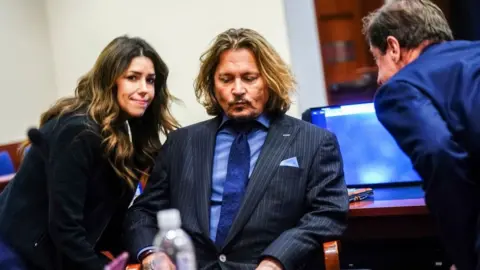 Getty Images Johnny Depp huddles with his legal team