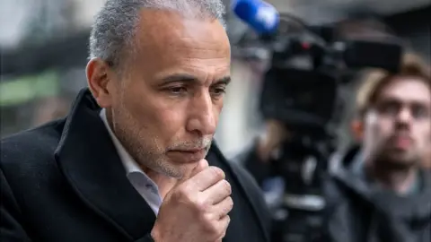 Getty Images Swiss Islamic scholar Tariq Ramadan arrives for the second day of his trial at the Geneva court, 16 May 2023
