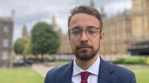 MP Luke Charters in front of Parliament