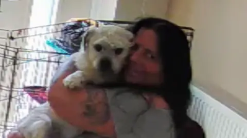 Handout Dog being hugged by owner