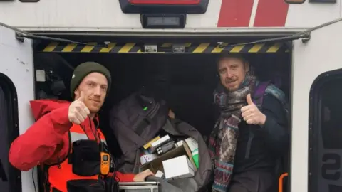 Jen Savaris Paramedic and volunteer showing donations in ambulance