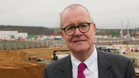 Patrick Vallance on building site.