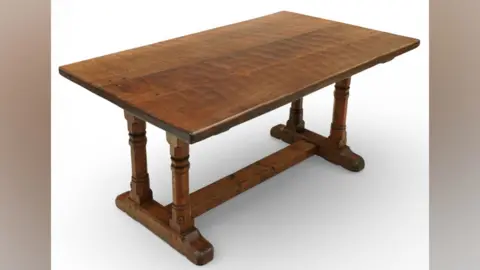 Duggleby Stephenson A table made by Robert Mouseman Thompson - it is an oak table on a white backdrop. 