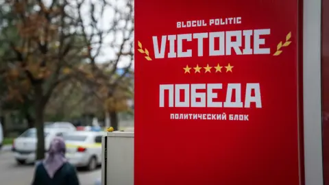 Matthew Goddard A red sign for the pro-Russian Victory party pictured on the street in Chisinau