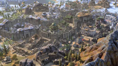 Firaxis A computer generated image showing a walled city with a mountain in the foreground and snow on the roofs of buildings