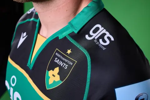 Northampton Saints New Saints crest as seen on a player jersey.