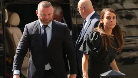 PA Media Coleen and Wayne Rooney arriving at London's Royal Courts Of Justice on Thursday morning