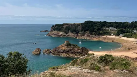 Portelet - a beach and rocky shore with calm sea