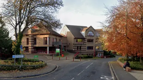 Google Brick building with red frames and rails